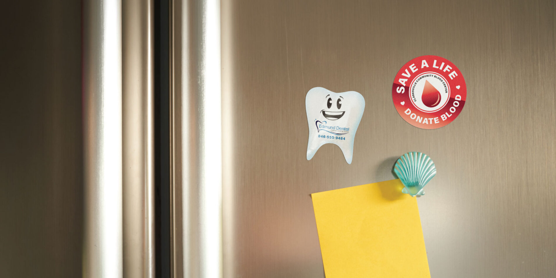 Custom tooth-shaped dental magnet and blood donation magnet displayed on a refrigerator